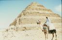 Camel rider in front of the stepped Pyramid of Saqqara.